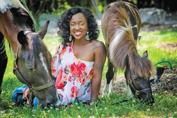 Abriana sits with her horses: Maestro (left) and Encore (right)