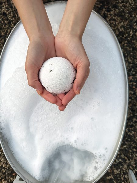 A bath bomb being held.