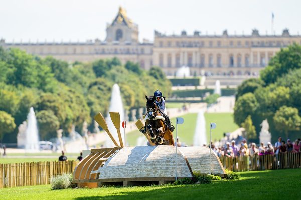 Laura Collett and London 52 on the 2024 Paris Olympics cross-country course with the Palace of Versailles setting the scene