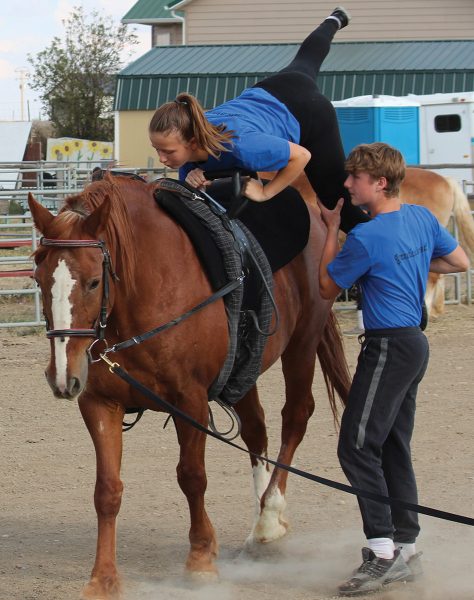 A coach helps a beginner with mounting