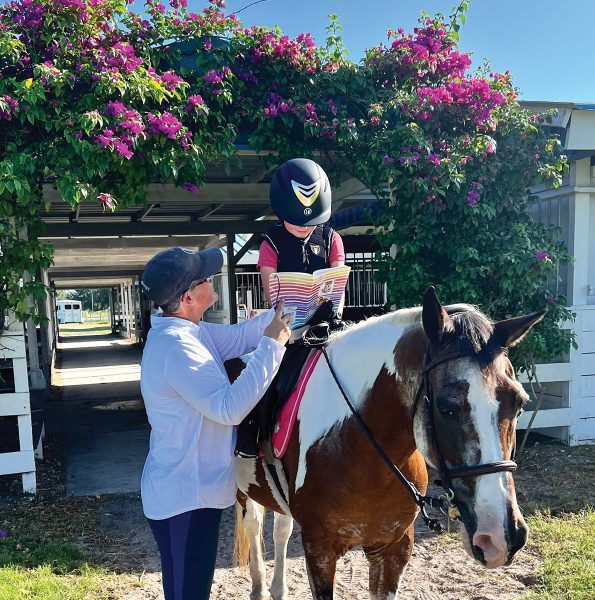 A trainer discusses points with a young rider.