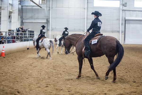 Riders in a western horsemanship class during the rail portion.